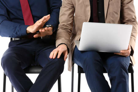 Man harassing his male colleague on white backgroundの写真素材