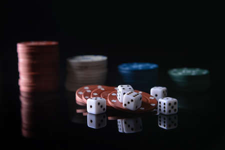 Poker chips and dices on dark backgroundの写真素材