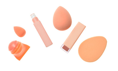 Set of lipsticks with makeup sponges on white backgroundの写真素材