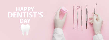 Hands of dentist with tools and tooth on color background. World Dentist Day