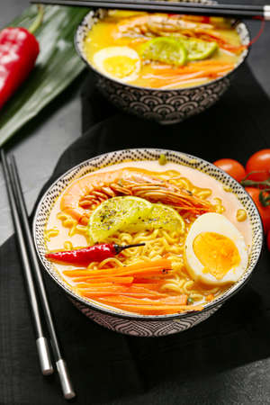 Bowl of tasty Thai soup on dark backgroundの写真素材