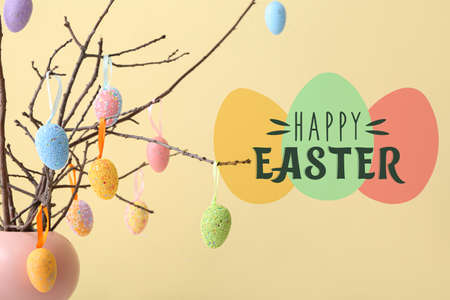 Creative greeting card for Easter celebration with eggs hanging on tree branches