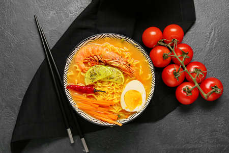 Bowl of tasty Thai soup on dark backgroundの写真素材