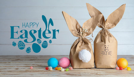 Greeting card with creative gifts and painted Easter eggs on table