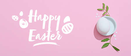 Egg and text HAPPY EASTER on color background