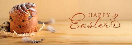 Delicious cruffin and text HAPPY EASTER on wooden background