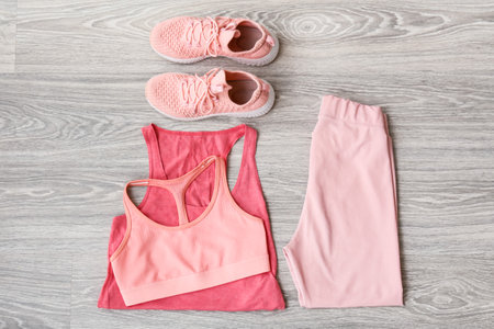 Sportswear and shoes on light wooden backgroundの写真素材