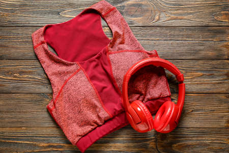 Sports top and headphones on wooden backgroundの写真素材