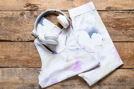 Sportswear and headphones on wooden backgroundの写真素材