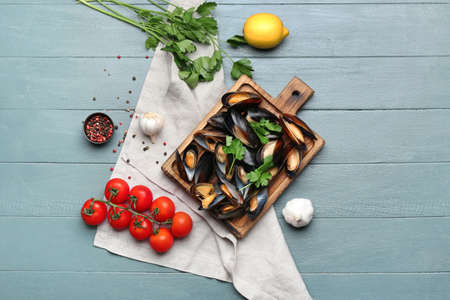 Composition with tasty mussels on color wooden background
