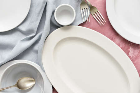 Different tableware and cutlery on color background, closeup
