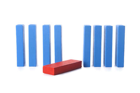 Red block among blue ones on white background. Concept of dismissal