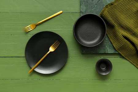Different tableware and napkin on color wooden backgroundの写真素材