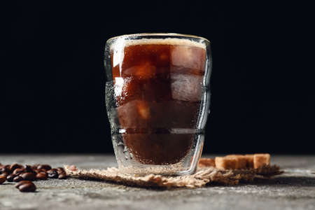 Glass of tasty iced coffee on tableの写真素材