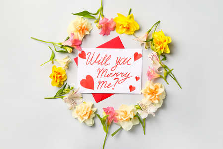 Beautiful flowers and text WILL YOU MARRY ME? on light background