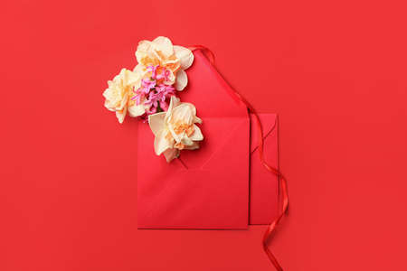 Beautiful flowers and envelope on color backgroundの写真素材