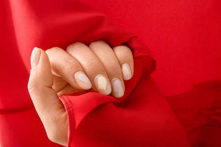 Young woman with beautiful manicure on color background