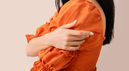 Fashionable young woman with beautiful manicure on color backgroundの写真素材