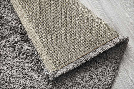 Gray carpet on wooden floor, closeupの写真素材