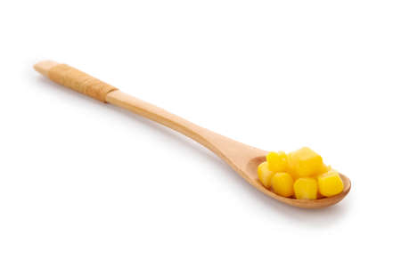Wooden spoon of corn kernels on white backgroundの写真素材