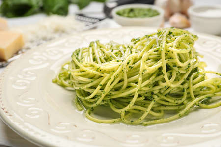 Plate with tasty pesto pasta, closeup