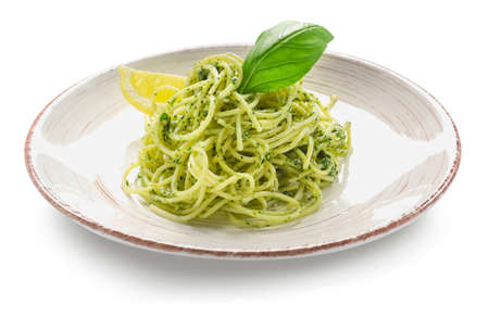 Plate with tasty pesto pasta on white background