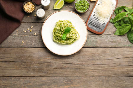 Plate with tasty pesto pasta on tableの写真素材