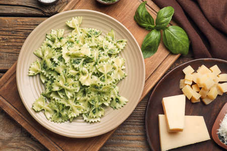 Plate with tasty pesto pasta on table
