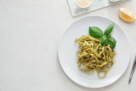 Plate with tasty pesto pasta on white backgroundの写真素材