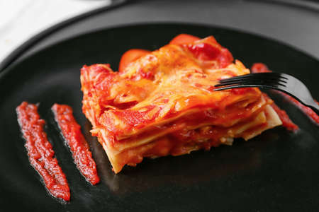 Piece of tasty tomato lasagna on plate, closeupの写真素材
