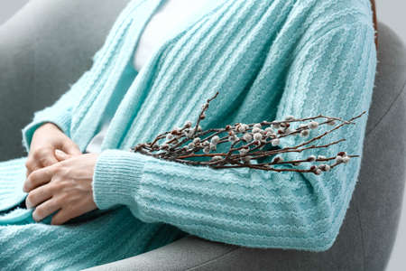 Beautiful woman with willow branches at home, closeupの写真素材