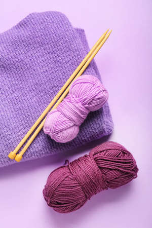 Yarn with knitting needles and plaid on color backgroundの写真素材