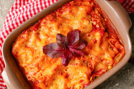 Baking dish with tasty tomato lasagna on table, closeupの写真素材