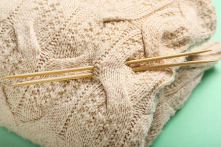 Plaid and knitting needles on color background, closeupの写真素材