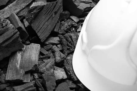 Miner's hardhat on char coal, closeupの写真素材