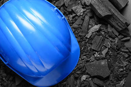 Miner's hardhat on char coalの写真素材