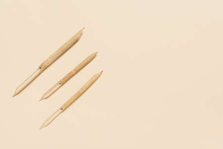 Wooden dip pen on beige backgroundの写真素材