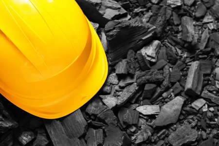 Miner's hardhat on char coalの写真素材