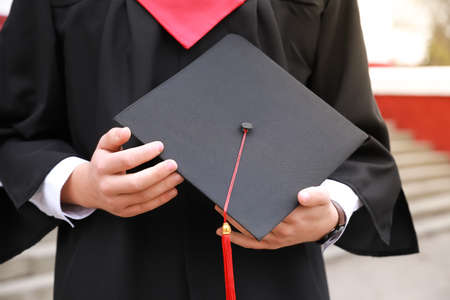 Male graduating student outdoors, closeupの写真素材