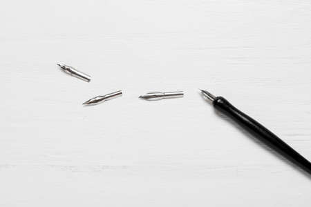 Nib pen on white wooden background
