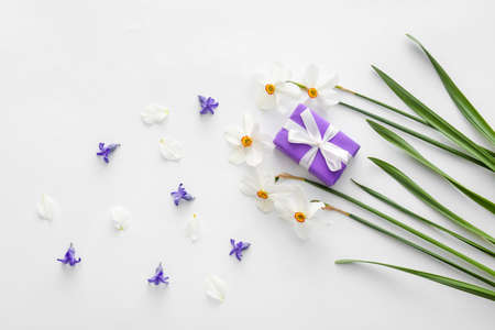 Beautiful composition with daffodils and gift box on white backgroundの写真素材