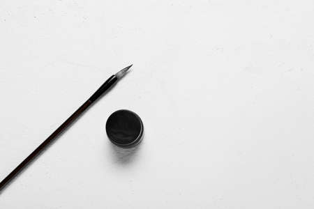Calligraphic brush with ink on white backgroundの写真素材