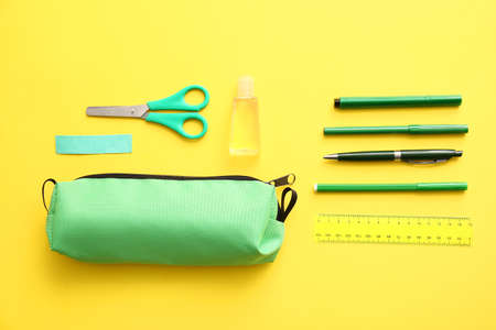 Pencil case with stationery on color backgroundの写真素材