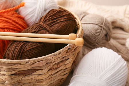 Basket with knitting yarn and needles, closeup