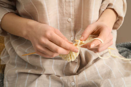 Young woman knitting at home, closeupの写真素材