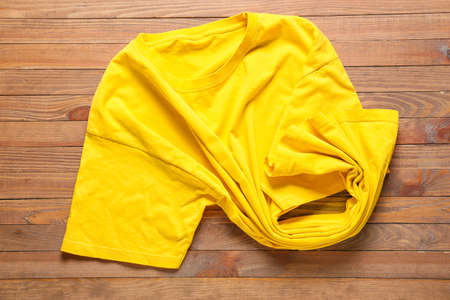 Stylish t-shirt on wooden backgroundの写真素材