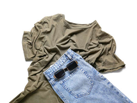 Stylish t-shirt, jeans and sunglasses on white backgroundの写真素材