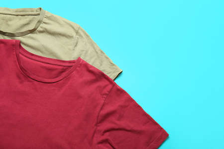 Stylish t-shirts on color background, closeupの写真素材
