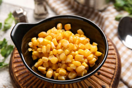 Bowl with corn kernels on table, closeup