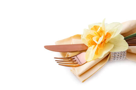 Stylish cutlery and narcissus flower on white backgroundの写真素材